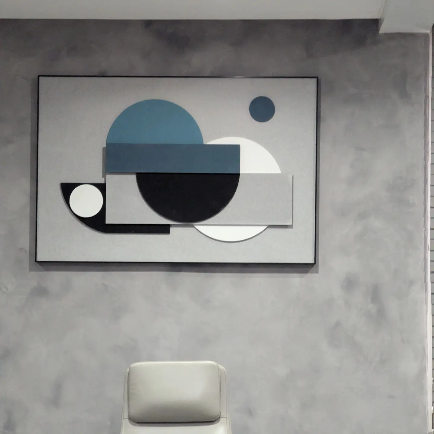 Textured grey feature wall with geometric framed artwork