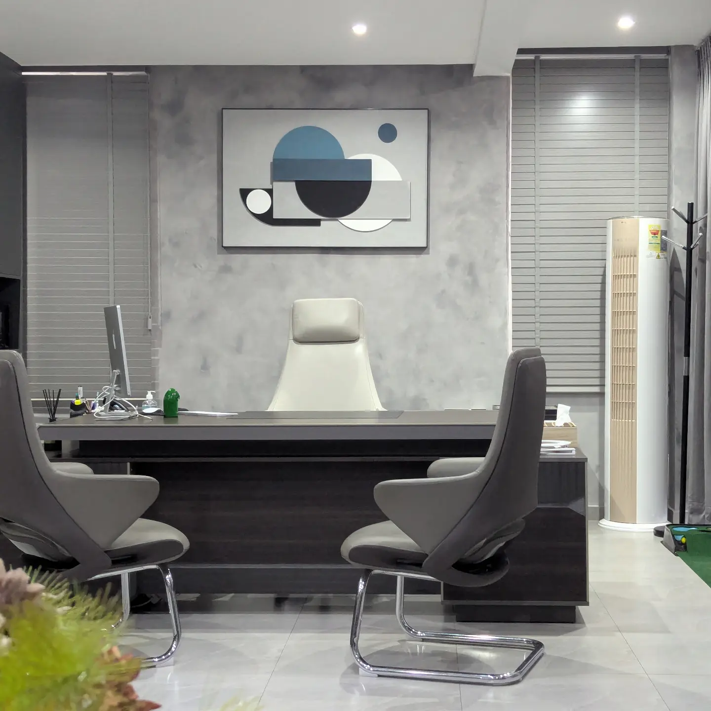 Executive office with L-shaped desk and high-back leather chair