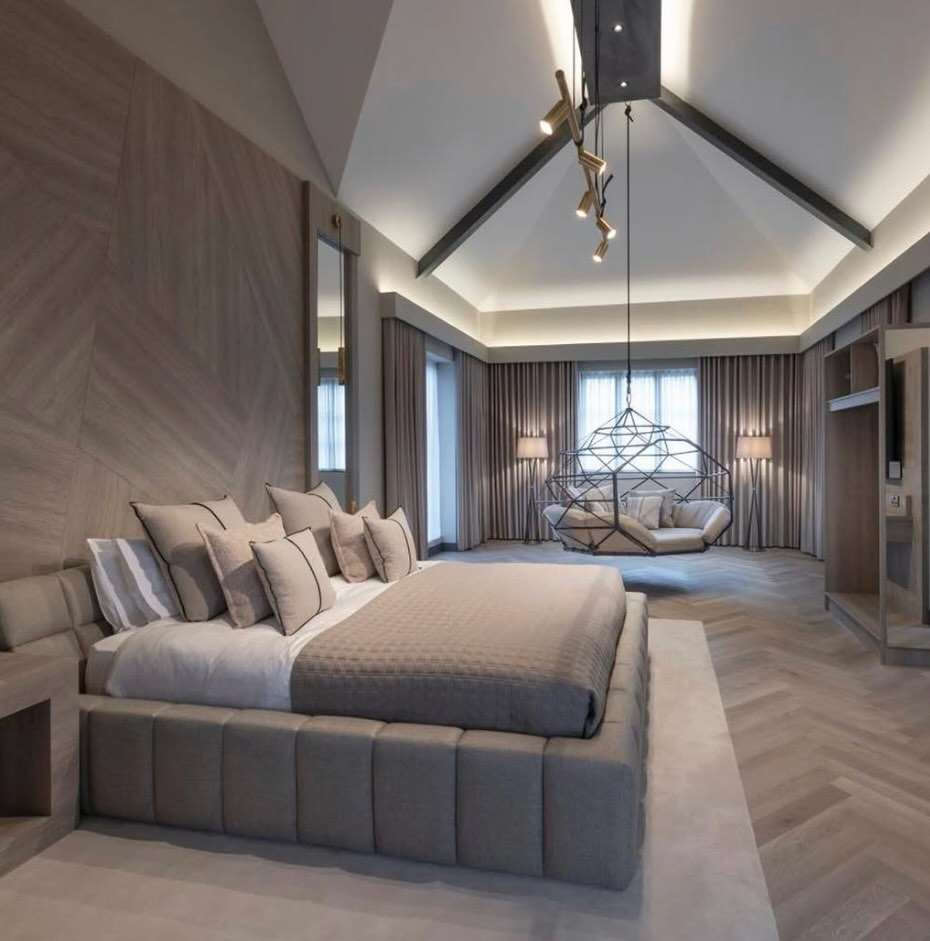 Master bedroom with vaulted ceiling and a hanging lounge swing